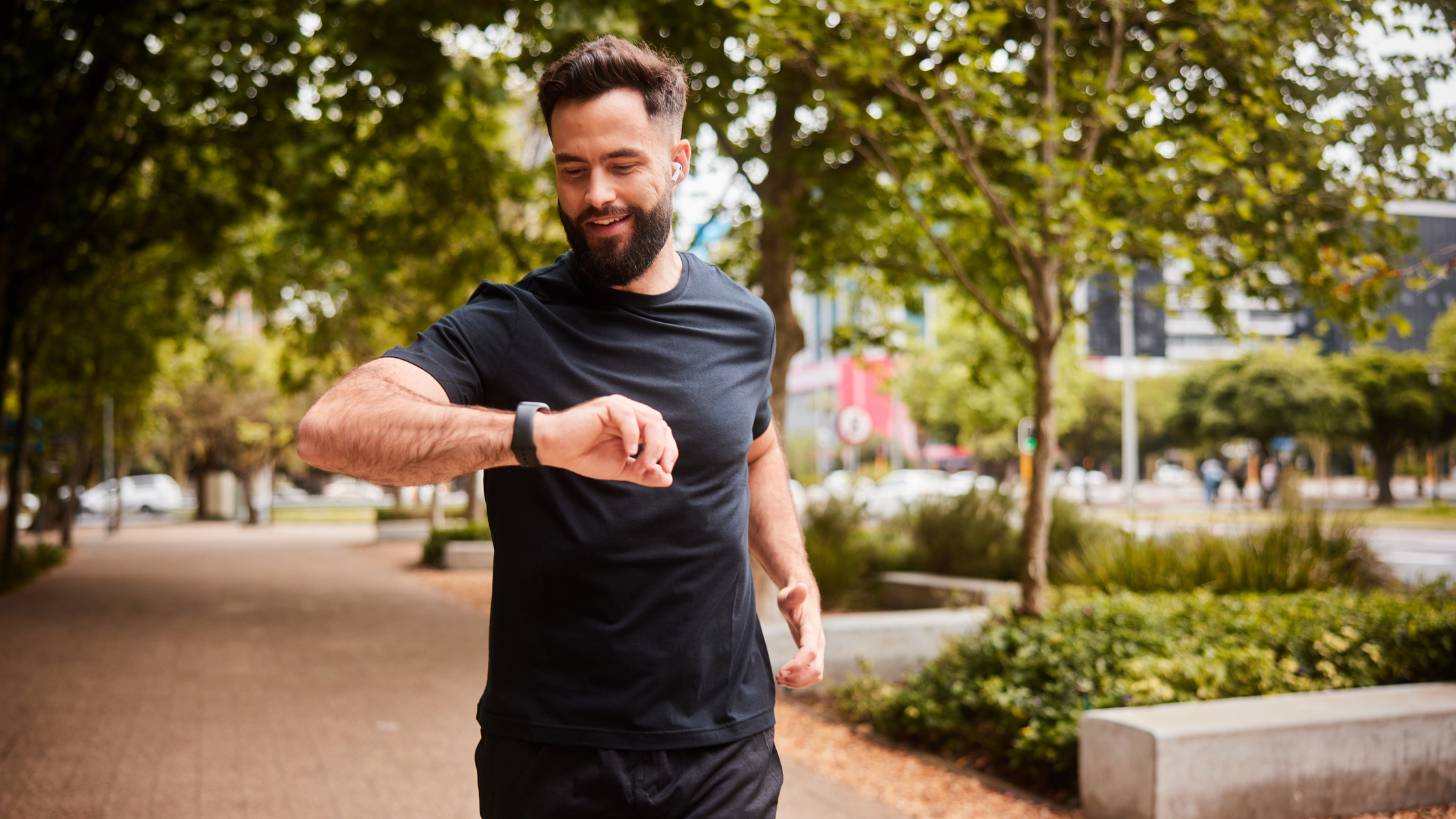 Male runner looking at his watch